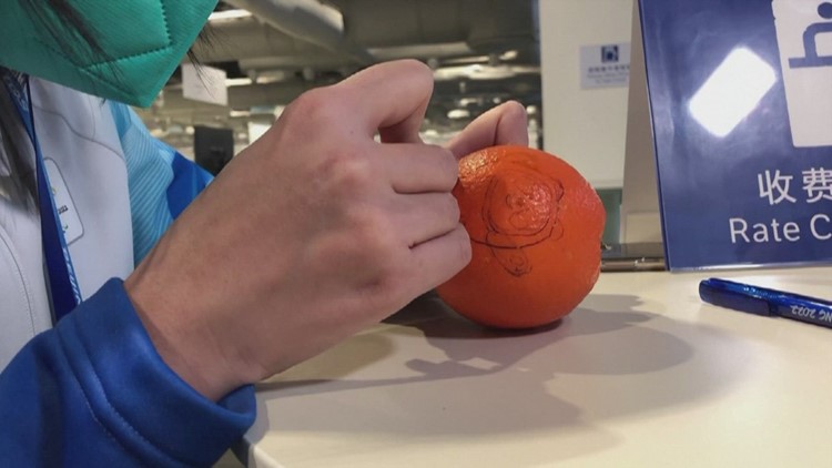 Check Out This Olympic Volunteer's Amazing Orange Carving
