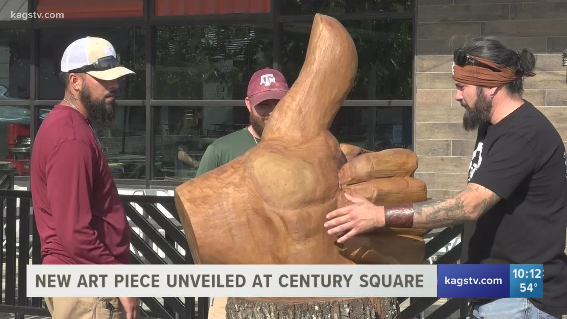 Reverend Butter masterfully sculpted an Aggie thumb out of an oak tree that died during the devastating Texas Winter Storm.
