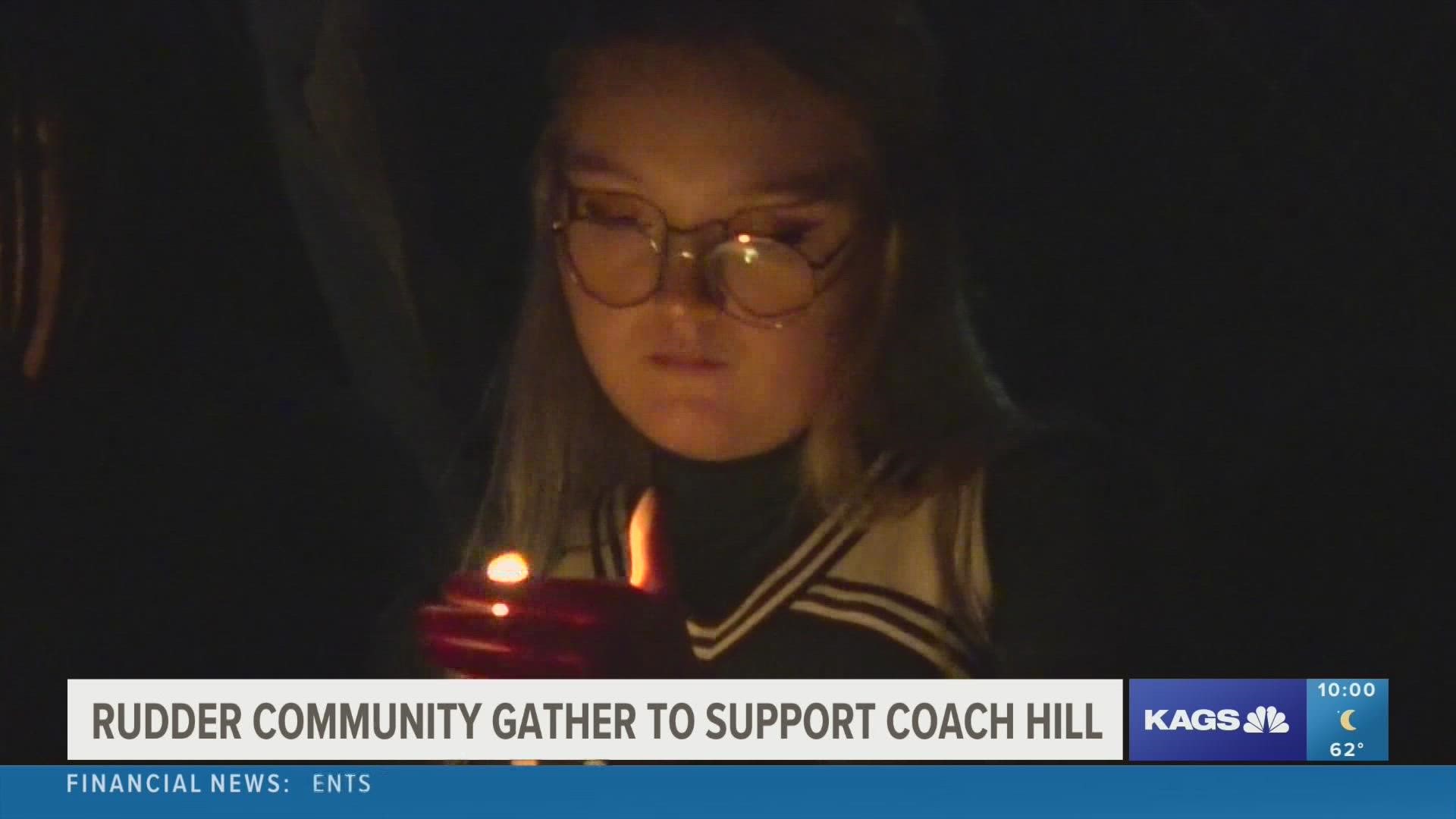 A candle lighting and prayer were held for coach Calvin Hill of Rudder High School, who is currently recovering from a crash that nearly cost him his life.