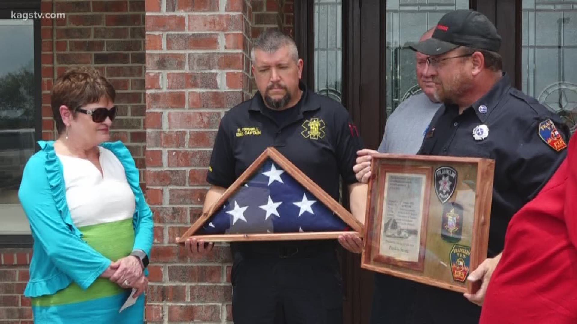 The flag was gifted to the SouthStar Bank, as debris continued to be picked up. Officials say the debris of the 55 buildings destroyed has been entirely placed on empty lots.