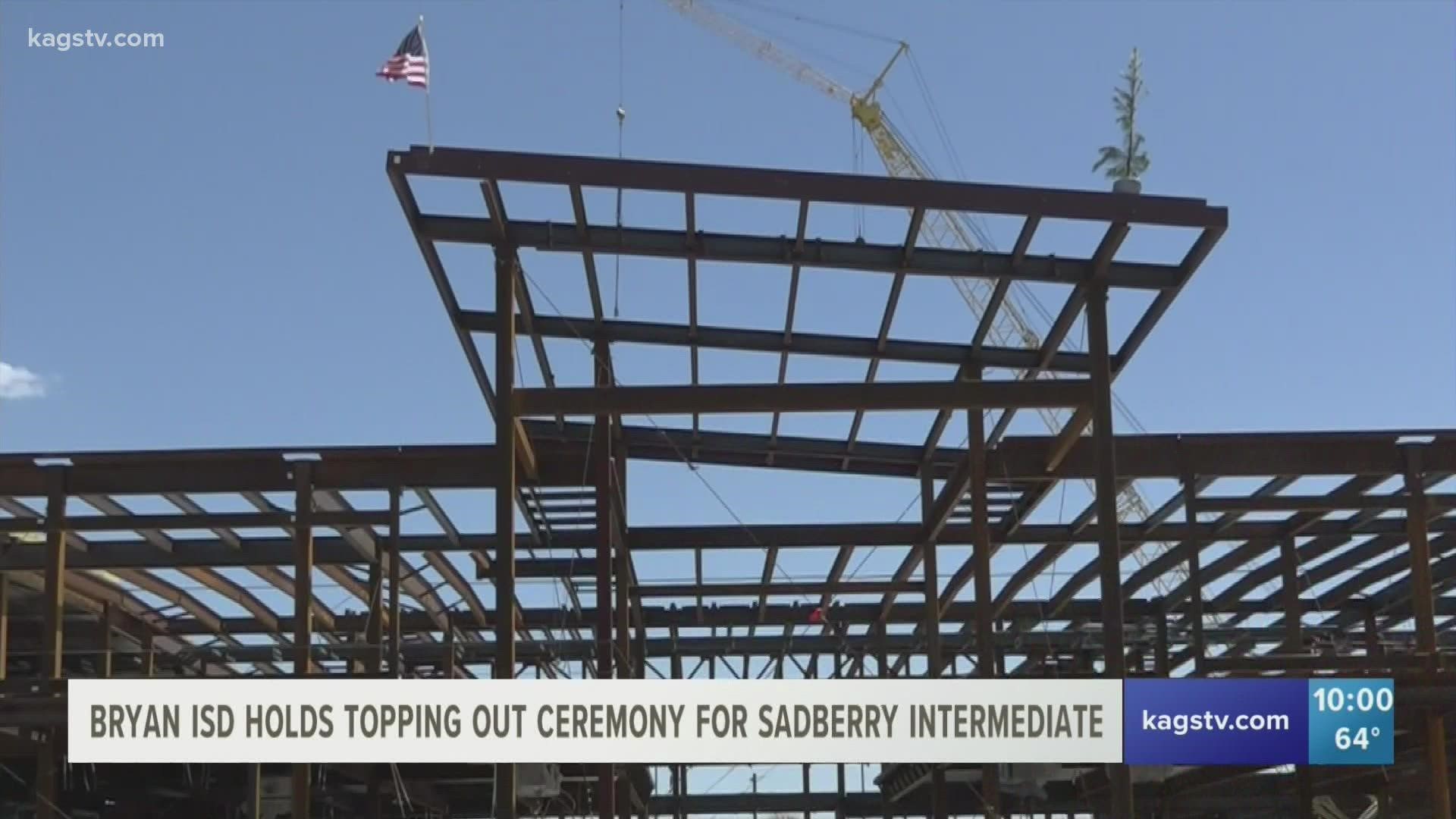 What is a topping off ceremony? Why is there a tree on top of the building?